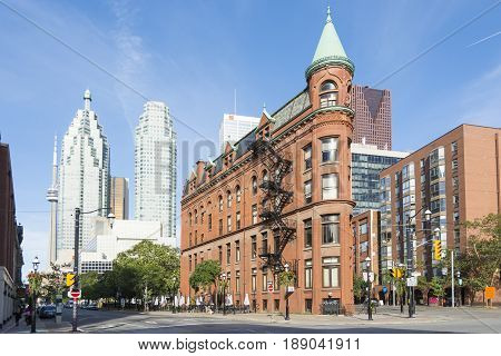 TORONTO,CANADA-AUGUST 2,2015:view of the Gooderham Building (the Flatiron Building) in downtown Torontowith some modern buildings and skyscrapers in the background during a sunny day.