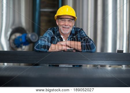 Portrait of male factory worker at drinks production factory