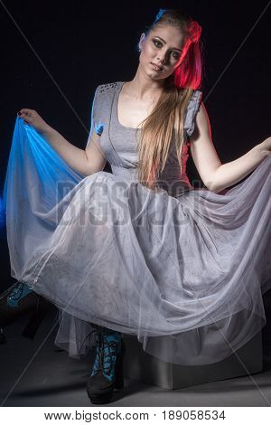 Actress In A Grey Dress On A Dark Stage