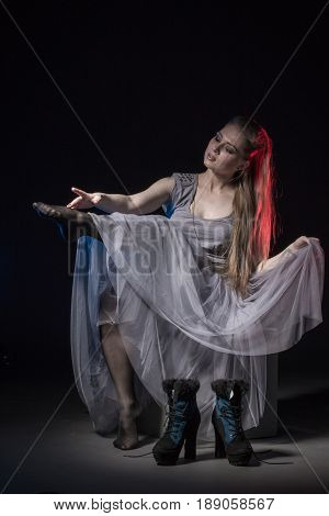 Actress In A Grey Dress On A Dark Stage