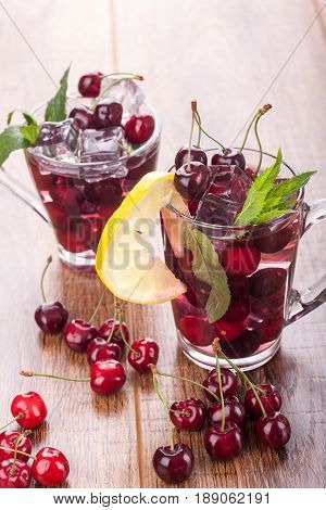 Ice cream and cherry juice on wooden background