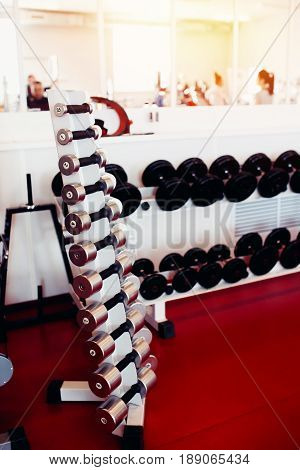 Sports equipment dumbbell rests in a row.  hign contrast and monochrome color tone