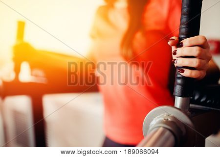 Girl doing muscle press exercise. in the gym. hands close-up.  hign contrast and monochrome color tone