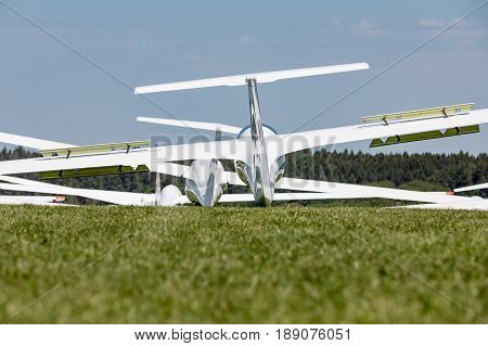 Glider on the grassy airfield in sunny day.