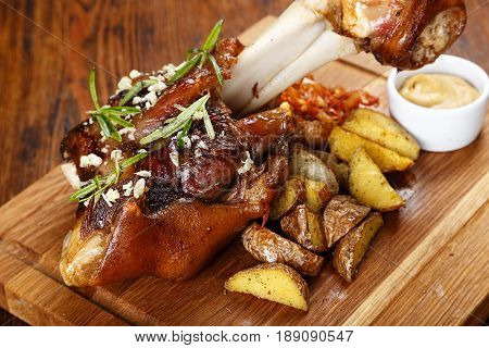 on the table board with cooked shank potatoes and sauerkraut mustard. top view
