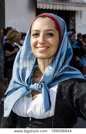 SELARGIUS, ITALY - SEPTEMBER 13, 2015: Ancient celibacy selargino - portrait of a beautiful smiling woman of the folk group Intragnas of Porto Torres - Sardinia