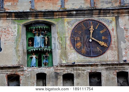 Medieval clock in the main tower. Medieval city Sighisoara. Urban landscape in the downtown of the medieval city Sighisoara, Transylvania