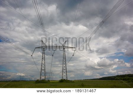 high voltage wires lines on cloudscape background at rainy day