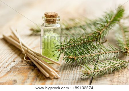 natural fir branches and spruce bath salt on wooden table background