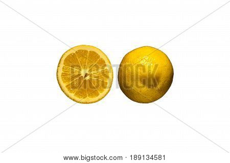 Freshly cut half and whole lemons on rustic boards.
