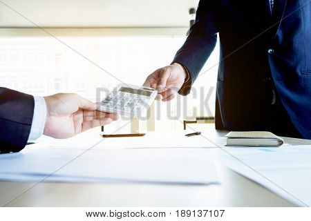 businessman send calculator to manager for estimation working invesment concept.