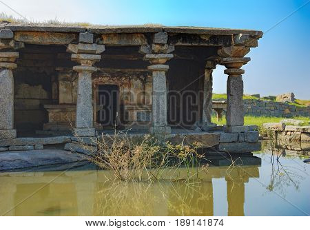 View of ancient ruins on Hemakuta hill in Hampi, Karnataka, India. Landscape with amazing stones tropical nature and temple. UNESCO World Heritage Site