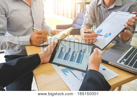 Teamwork process Business team colleague presenting and showing graph on tablet and clipboard at workplace in office. brainstorming discussing meeting.