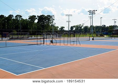 Empty blue tennis hardcourt on sunny day