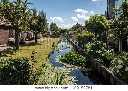 Marken Netherlands - August 08 2016. Picturesque traditional houses in Marken. It is known for its characteristic wooden houses and traditional costumes.