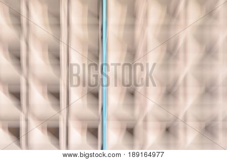 Abstract motion blur background of concrete wall with square cells geometrical pattern