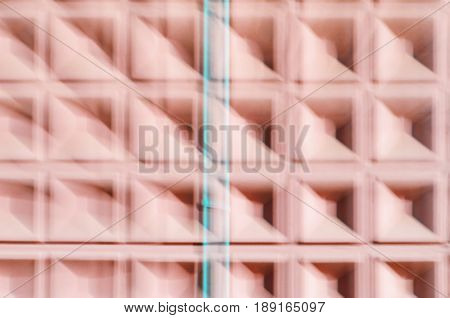 Abstract motion blur background of red concrete wall with square cells geometrical pattern
