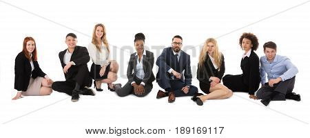 Group Of Happy Multiracial Businesspeople Sitting On White Background