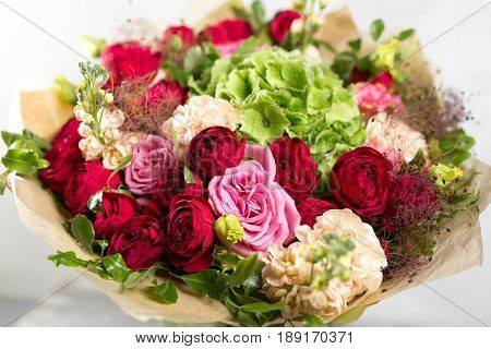 Still life with a bouquet of flowers. the florist put together a beautiful bunch of flowers. Man manual work used different types of flowers and colors.