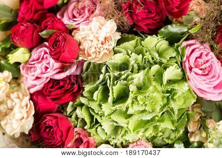 Still life with a bouquet of flowers. the florist put together a beautiful bunch of flowers. Man manual work used different types of flowers and colors.