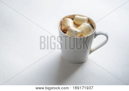 Cup Of Coffee with Marshmallows. White mug of hot drink with copy space background