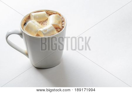 Cup Of Coffee with Marshmallows. White mug of hot drink with copy space background