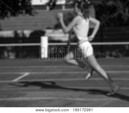 Black And White Blurred View Of Running Girl At Stadium