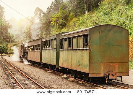 Steam narrow-gauge train with local people stands at the station on the way from Yuejin to Bagou. Jiayang Mining Region. Sichuan province. China