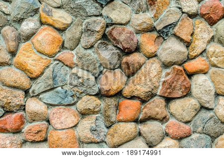 Rubble masonry wall. Stone wall made of various sizes stone can be used as background.
