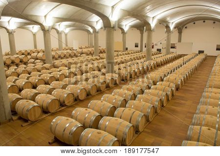 Wine barrels stacked in the cellar of the winery Marsala Sicily
