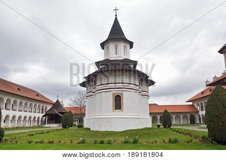 arched colonade and church of Sambata de Sus monastery in Transylvania Romania