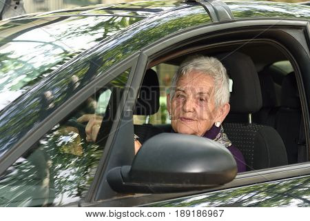 portrait of a senior woman driving a car