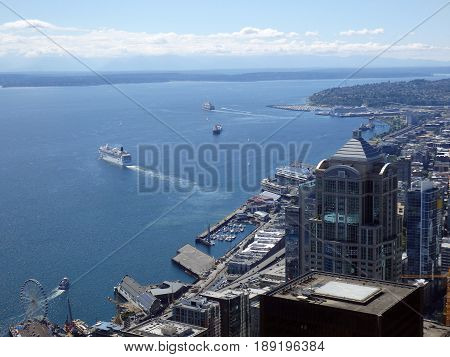 SEATTLE-- JUNE 25: Aerial view of Puget Sound with boats leaving harbor downtown Seattle buildings Wharf and Highway on June 25 2016 in Seattle WA.