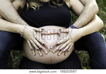 Couple pregnant boyfriends in nature maternity and love