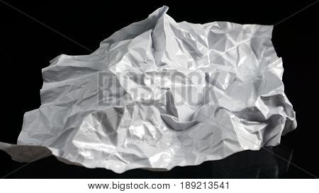 The garbage can recycle. White paper on the black mirror background