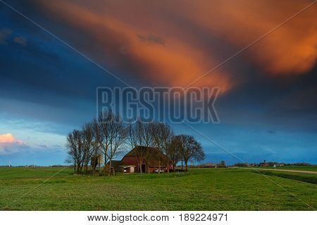 Farm house in the Frisian Country side during sunset.