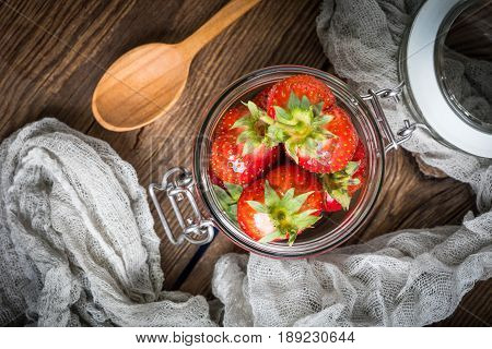 Strawberry In Jar On Wooden Background.