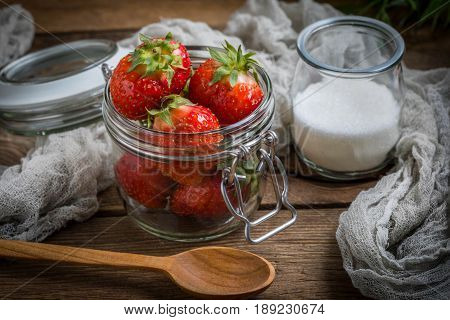 Strawberry In Jar On Wooden Background.
