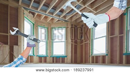 Digital composite of Hands holding tools during renovation of house