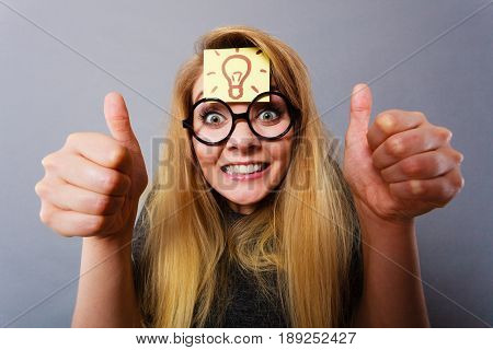 Woman Having Light Bulb Mark On Forehead Thinking