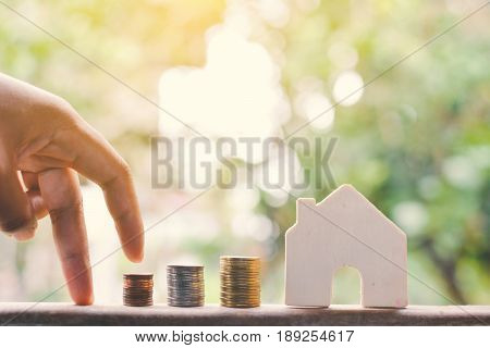 Female hand and coins concept save money for my home selective and soft focus vintage tone