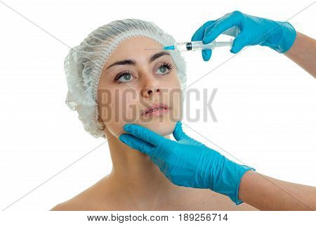 cosmetologist in gloves conducts procedures on the face of the girl with the help of injections is isolated on a white background close-up