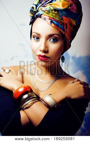 beauty bright real african woman with creative make up, shawl on head like cubian closeup smiling
