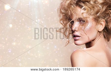 Close-up portrait of beautiful woman with bright make-up and hairstyle. On a particle backbround