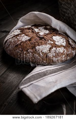 Traditional Whole Grain Rye Bread on Dark Wooden Table Background