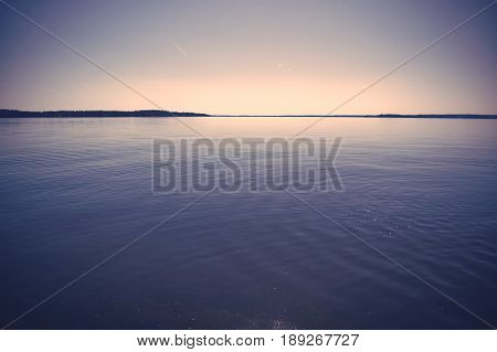 Evening sunset in Sweden with still water.