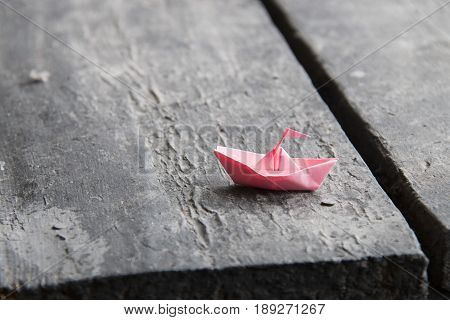 paper boat on old wooden table, journeyconcept