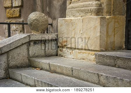 Photo of several steps with stone texture and sunlighht