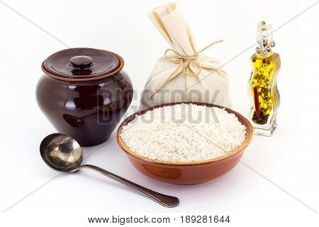 The Composition Of Rice Groats In A Clay Pial Next To A Clay Pot And A Copper Spoon,