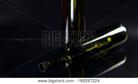 The green glass bottles or wine bottles on black background, the garbage can recycle.